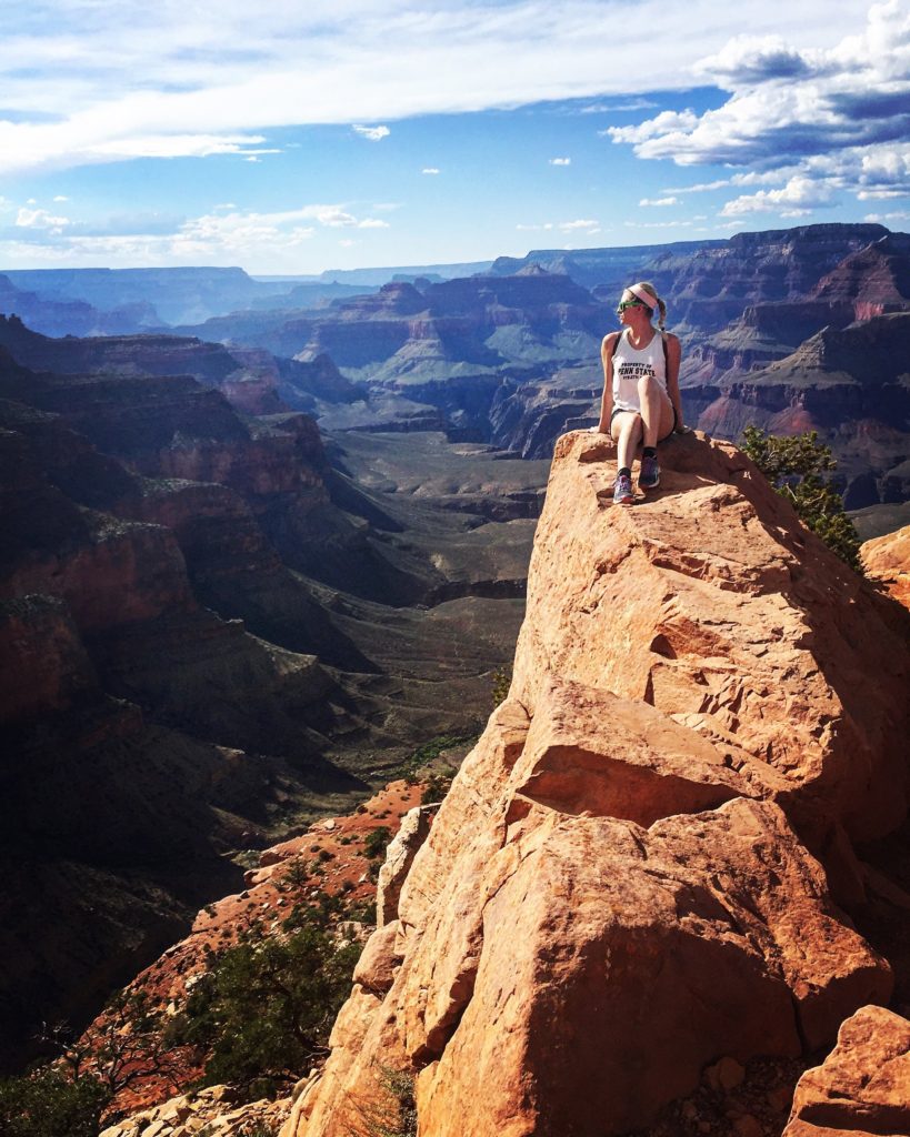 girl sitting on a cliff at the Grand Canyon