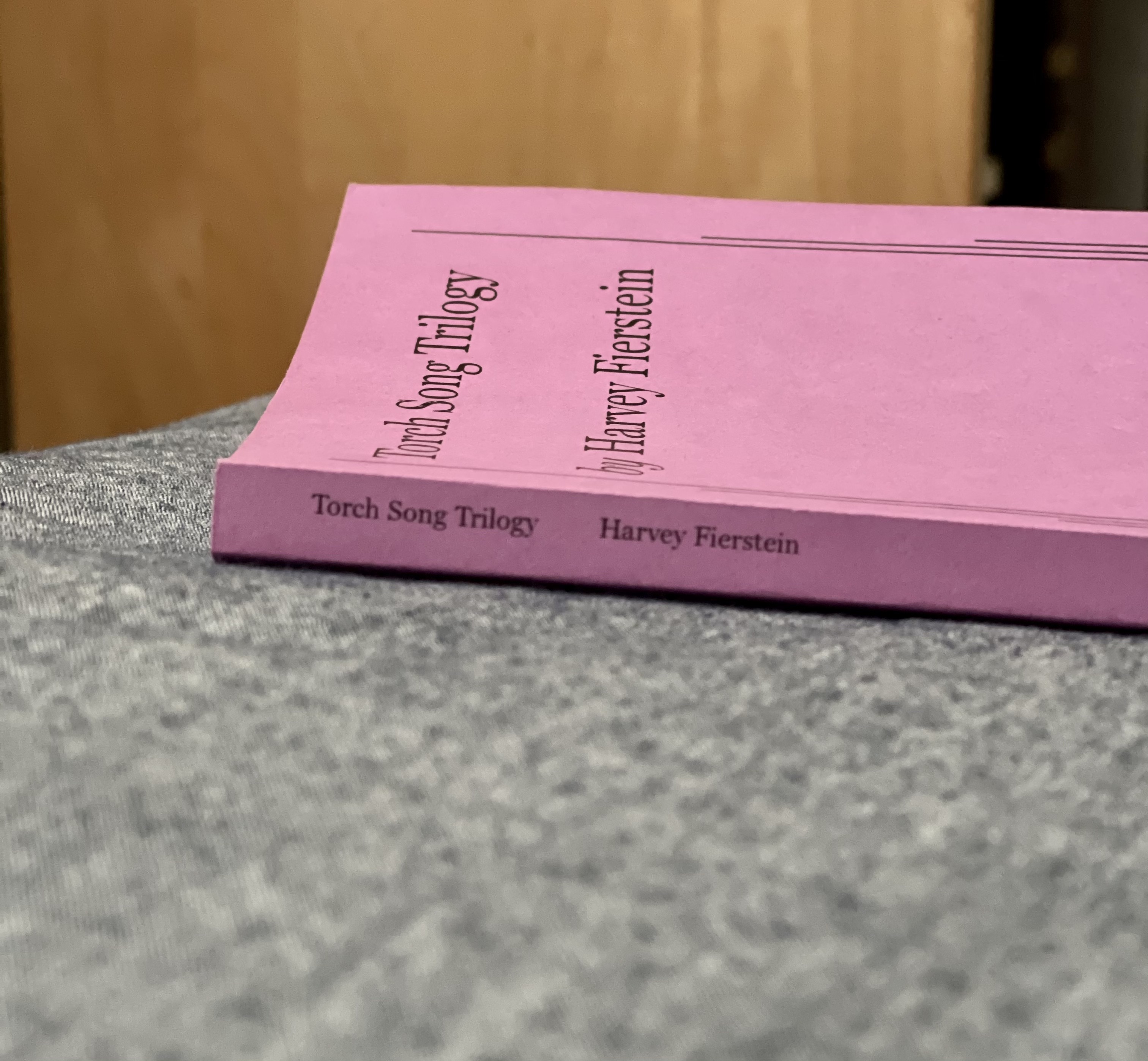 pink play book, on its side showing the title