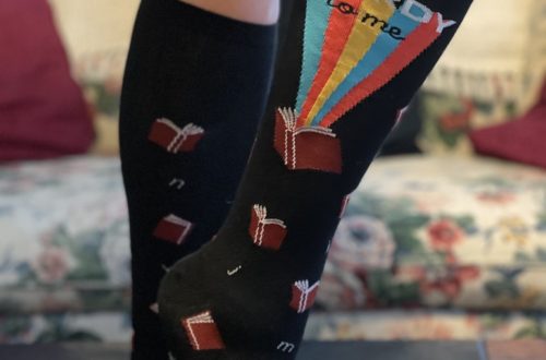 knee-high, black socks with books on them and say "Talk Wordy to Me"