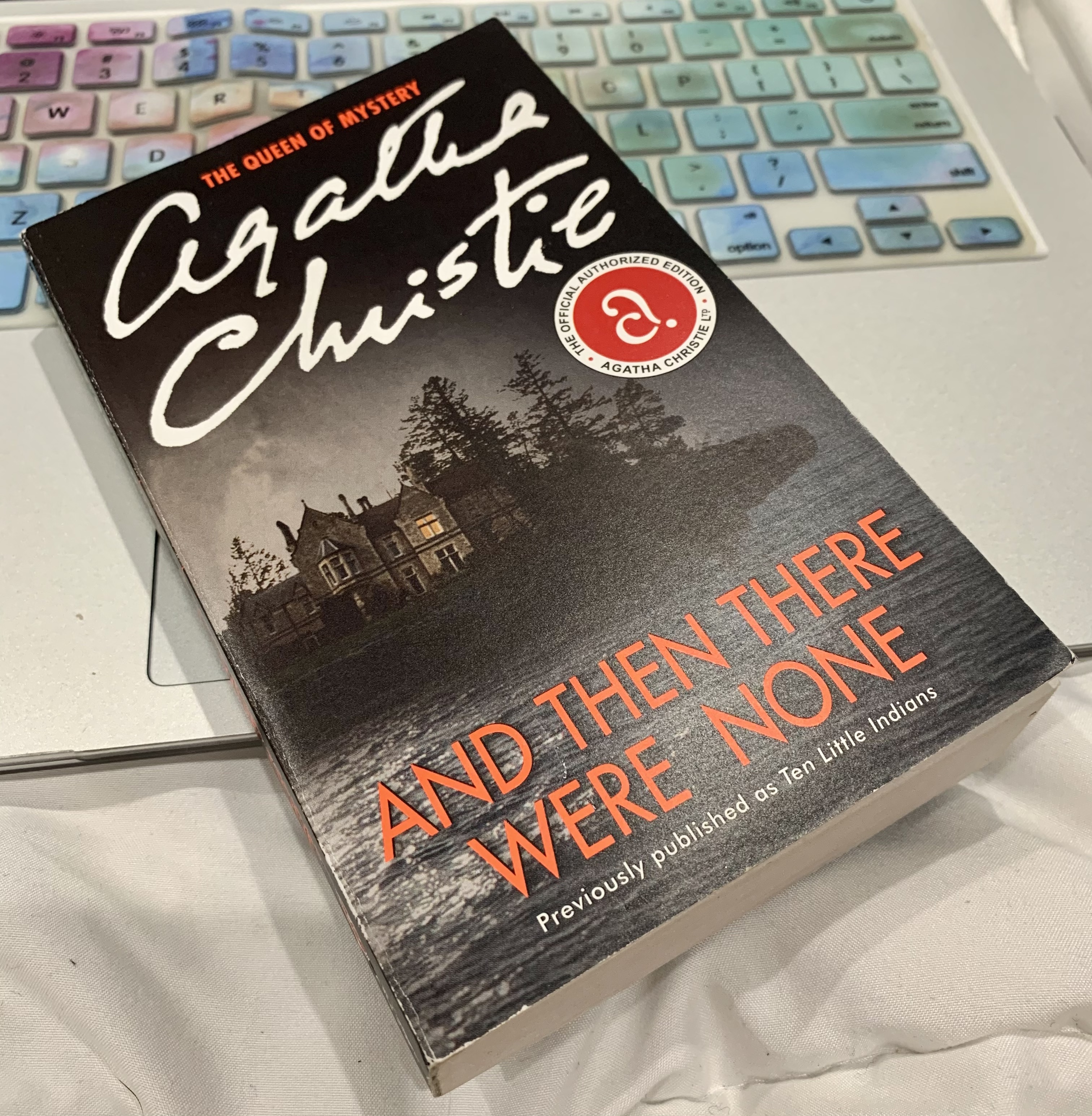 And Then There Were None book by Agatha Christie sitting on open laptop