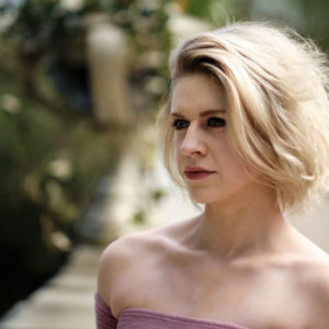 portrait picture of a blonde woman with short hair looking past the camera